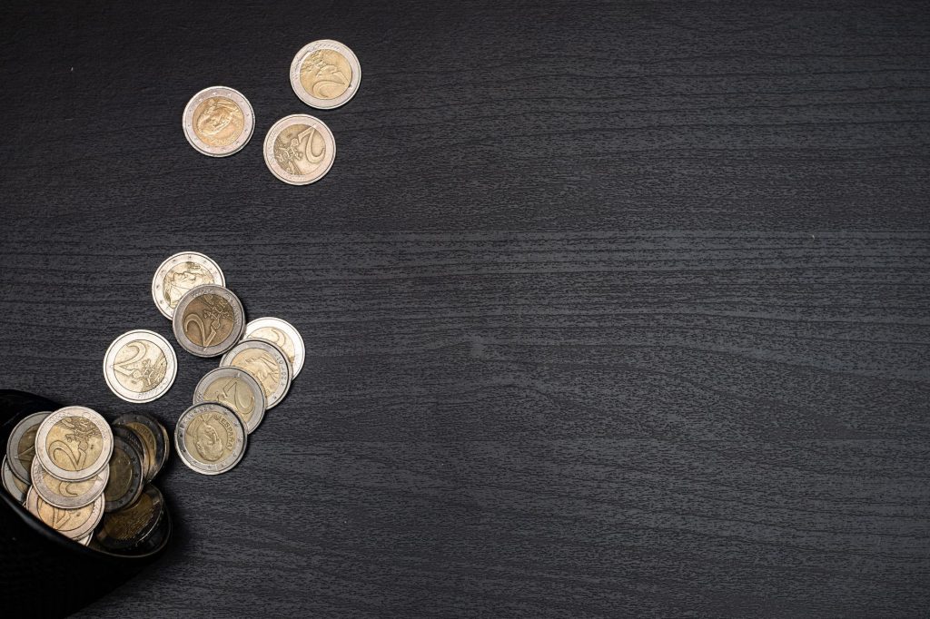 gold round coins on black textile