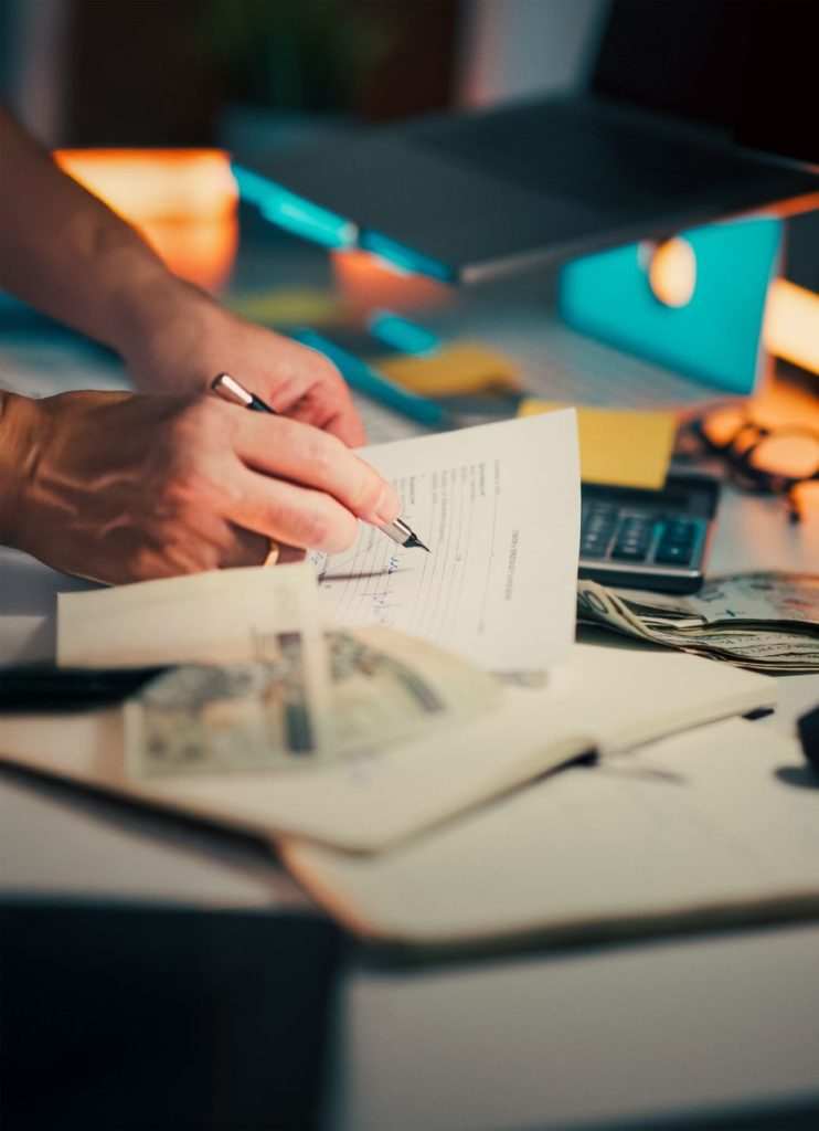 business desk with financial documents and cash