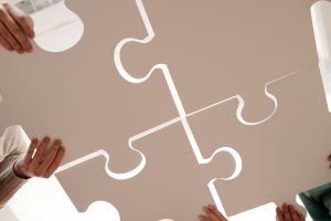 close up photo of people holding puzzle pieces