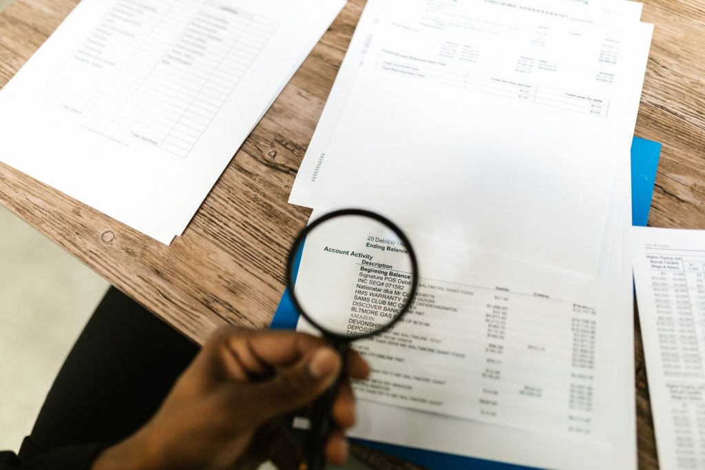 a person using a magnifying glass on a document