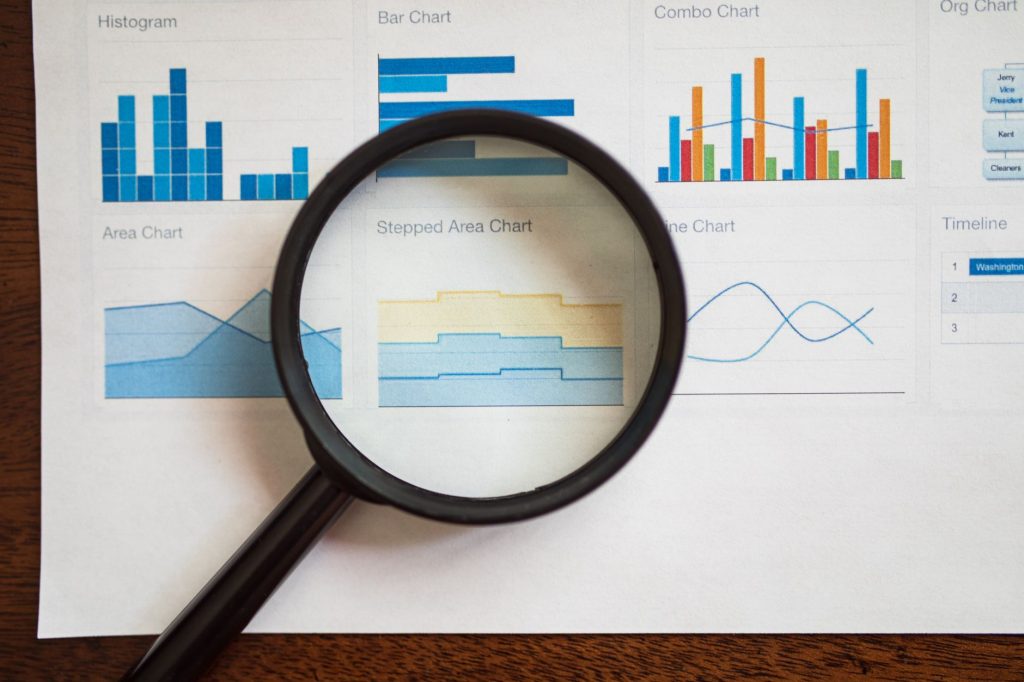 a magnifying glass on a page of various charts